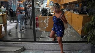 موظفة بنك تخرج عبر نافذة كسرها المهاجمون في بيروت، لبنان. 2022/09/14