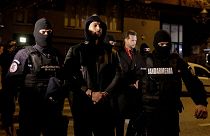 Andrew Tate and Tristan Tate are escorted by police officers outside the headquarters of the Directorate for Investigating Organized Crime and Terrorism in Bucharest (DIICOT) 