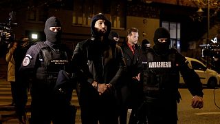 Andrew Tate and Tristan Tate are escorted by police officers outside the headquarters of the Directorate for Investigating Organized Crime and Terrorism in Bucharest (DIICOT) 