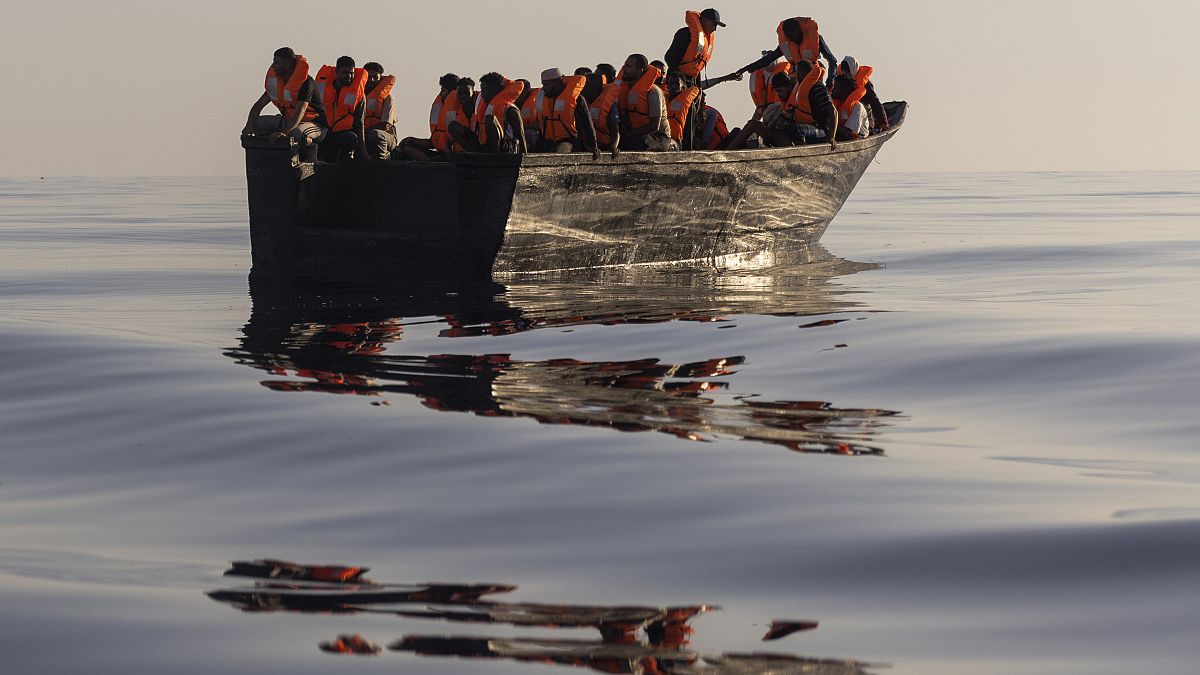 Migrants with life jackets provided by volunteers of the Ocean Viking rescue ship.