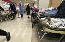 Elderly patients rest in an area cordoned off to provide intravenous drips at a hospital in Beijing, 31 December 2022