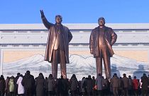 Crowds lay flowers and bow at giant statues of former leaders Kim Il Sung and Kim Jong Il in Pyongyang