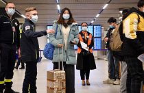 Passengers on a flight from China get COVID documents checked at after arriving at the Paris-Charles-de-Gaulle airport, Sunday 1 January 2023