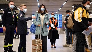 Passengers on a flight from China get COVID documents checked at after arriving at the Paris-Charles-de-Gaulle airport, Sunday 1 January 2023