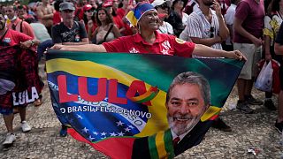 A supporter of Luiz Inacio Lula da Silva displays a banner during his inauguration as new president in Brasilia, 1 January 2023