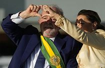 President Luiz Inacio Lula da Silva, left, and his wife Rosangela Silva form a heart with their hands after he was sworn in.