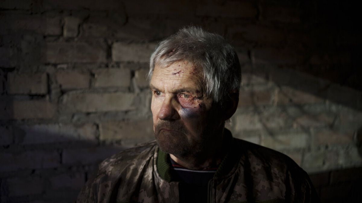 Anatolii Kaharlytskyi, 73, stands inside his house, heavily damaged after a Russian attack in Kyiv, Ukraine, Monday, Jan. 2, 2023. 