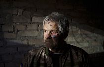 Anatolii Kaharlytskyi, 73, stands inside his house, heavily damaged after a Russian attack in Kyiv, Ukraine, Monday, Jan. 2, 2023.