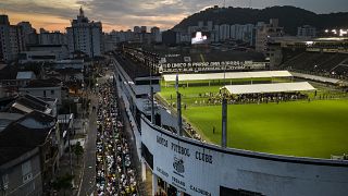 Fans queue for hours for last goodbyes to Pelé in Santos, Brazil.