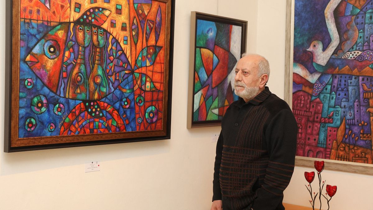 علي شمس الدين أمام لوحاته في "دار المصور" في بيروت 