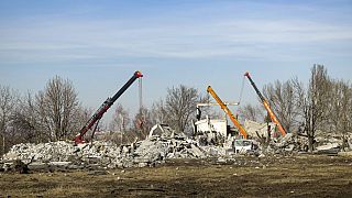 Workers clean rubbles after a Ukrainian rocket strike in Makiivka, in the Russian-controlled Donetsk region, in the country's east. 