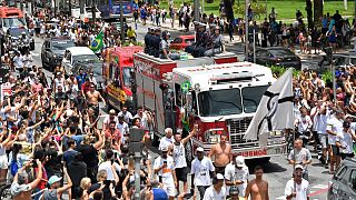 The remains of late Brazilian soccer great Pele are transported on a firetruck from Vila Belmiro stadium to the cemetery during his funeral procession in Santos, Brazil