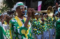 Performers play music, sing and dance as they take part in the Minstrels Parade in Cape Town on 2 January.