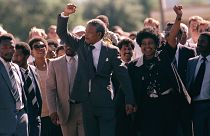 Nelson Mandela and wife Winnie, walking hand in hand, raise clenched fists upon his release from Victor prison, Cape Town, Sunday, February 11, 1990