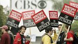 Picketers march outside the entrance to CBS Television City in Los Angeles as a strike by film and television writers got under way Monday, Nov. 5, 2007.