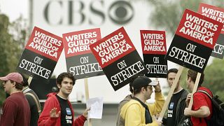 Picketers march outside the entrance to CBS Television City in Los Angeles as a strike by film and television writers got under way Monday, Nov. 5, 2007.