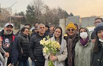 Iranian prominent actress Taraneh Alidoosti, center, holds bunches of flowers as she poses for a photo after being released from Evin prison in Tehran, 4 January 2023