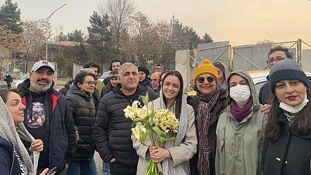 Iranian prominent actress Taraneh Alidoosti, center, holds bunches of flowers as she poses for a photo after being released from Evin prison in Tehran, 4 January 2023