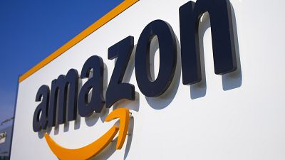 FILE - A company logo is seen at the entrance of Amazon, in Douai, northern France, on April 16, 2020.