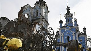 Destroyed domes lie next to a damaged church in the retaken village of Bohorodychne, eastern Ukraine, 22 October 2022