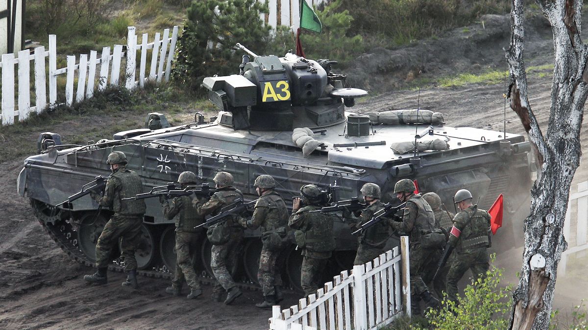 Soldiers follow a Marder infantry fighting vehicle during a demonstration event held for the media by the German Bundeswehr in Bergen near Hannover, September 2011