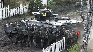 Soldiers follow a Marder infantry fighting vehicle during a demonstration event held for the media by the German Bundeswehr in Bergen near Hannover, September 2011