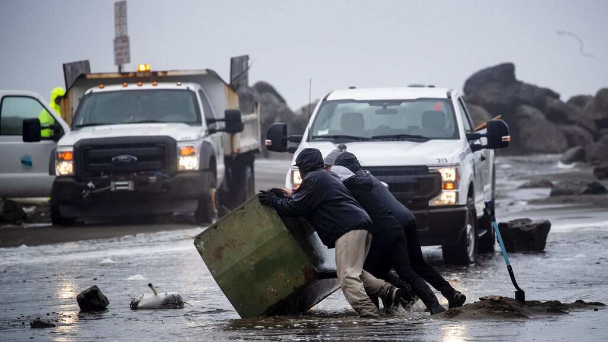 A munkások eltakarítják a törmeléket az elárasztott Clarendon Roadról Pacifica-ban, Kalifornia államban