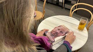 A woman holds a copy of "En La Sombra" (In the Shadow), the Spanish translation of Prince Harry's memoir "Spare" in Barcelona.