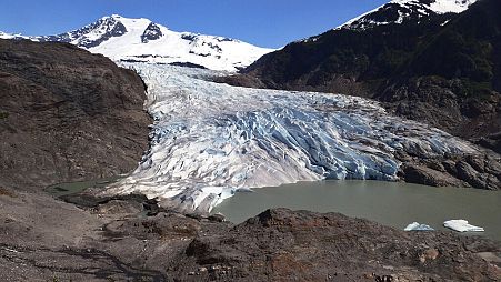 Chunks of ice float on Mendenhall Lake in front of the Mendenhall Glacier on Monday, May 30, 2022, in Juneau, Alaska.