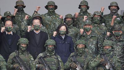 Taiwan President Tsai Ing-wen, center, poses with soldiers during a visit to the Penghu Magong military base in outlying Penghu Island, Taiwan.
