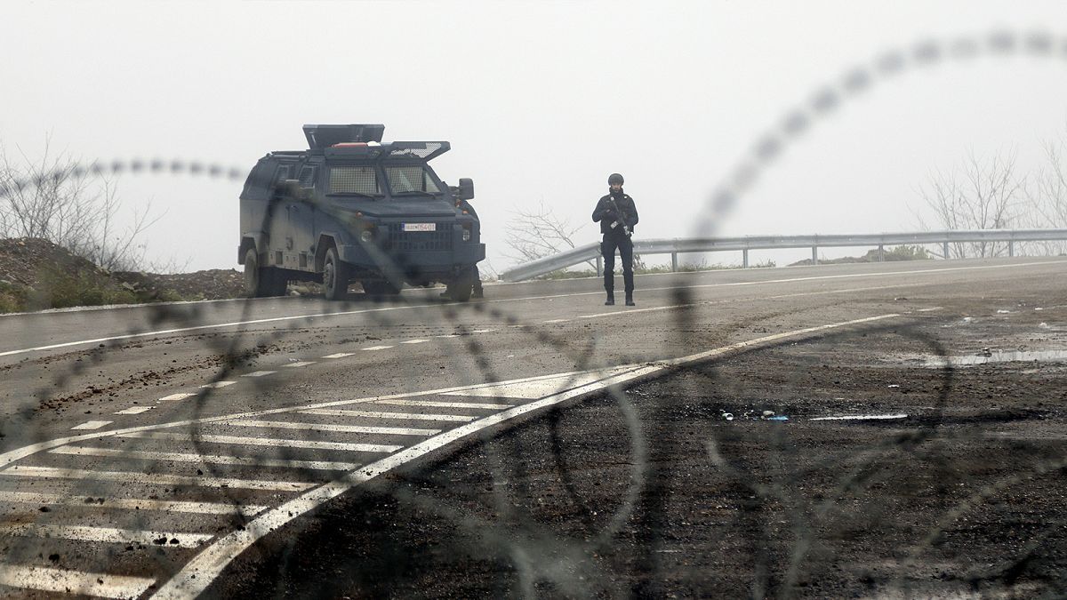 Kosovo police officers guard checkpoint on the road near the northern Kosovo border crossing of Jarinje, along the Kosovo-Serbia border, 30 December 2022