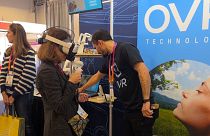 Stopping to smell virtual roses using OVR's wearable scent technology at CES in Las Vegas, USA, January 5, 2022.