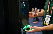 An exhibitor demonstrates the OneThird avocado ripeness checker during CES Unveiled