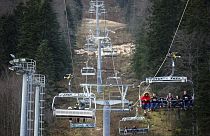People ride the chair lift above the ski track without any snow on Bjelasnica mountain near Sarajevo, Bosnia in this file photo