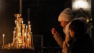 Worshippers pray at the Ukrainian Orthodox Saint Michael's Golden-Domed Monastery in Kyiv on January 6, 2023