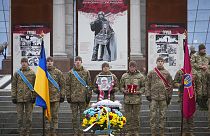 Ukrainian servicemen pay their last respect at the coffin of their comrade Oleh Yurchenko killed in a battlefield with Russian forces in the Donetsk, during a ceremony, 8 Jan.