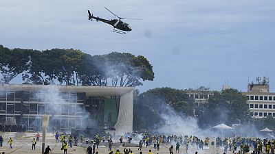 Protesters, supporters of Brazil's former President Jair Bolsonaro, clash with police as they storm the Planalto Palace in Brasilia, Brazil. Sunday, 8 January 2023.