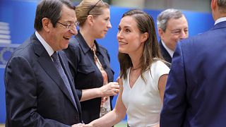 Cypriot President Nicos Anastasiades, left, greets Finland's Prime Minister Sanna Marin at an EU summit in Brussels, June 24, 2022.