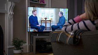 Brit nő nézi a tévében Harry herceg Tom Bradby-nek adott interjúját január 8-án - a herceg később más csatornáknak is nyilatkozott