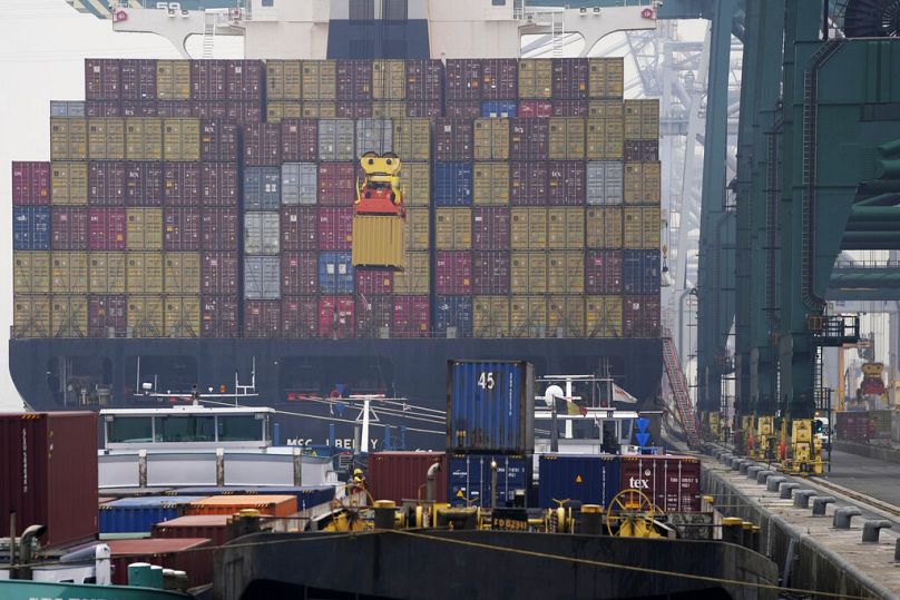 A container is loaded onto a ship in the Port of Antwerp, August 2022