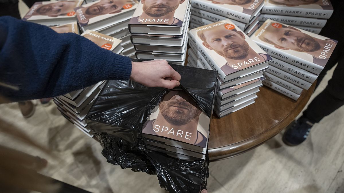 A staff member places the copies of the new book by Prince Harry called 'Spare' at a book store in London.