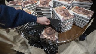 A staff member places the copies of the new book by Prince Harry called 'Spare' at a book store in London.