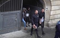 Tate brothers leave Romanian court in handcuffs