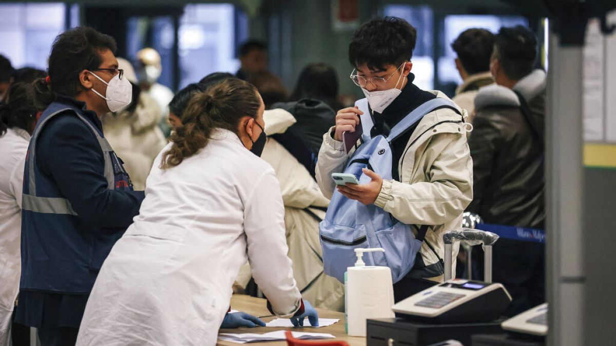 Passangers arriving from China are tested for COVID-19 on arrival at Milan Malpensa Airport, Milan, Italy, Thursday, Dec. 29, 2022. (Alessandro Bremec/LaPresse via AP)