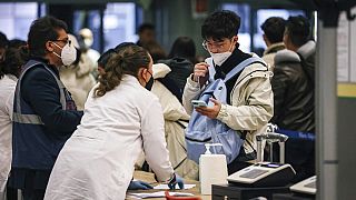 Passangers arriving from China are tested for COVID-19 on arrival at Milan Malpensa Airport, Milan, Italy, Thursday, Dec. 29, 2022. (Alessandro Bremec/LaPresse via AP)