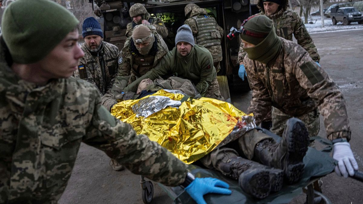 Ukrainian military medics carry an injured Ukrainian serviceman evacuated from the battlefield into a hospital in Donetsk region, Ukraine, Monday, Jan. 9, 2023