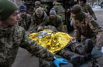 Ukrainian military medics carry an injured Ukrainian serviceman evacuated from the battlefield into a hospital in Donetsk region, Ukraine, Monday, Jan. 9, 2023