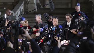 Lawyers for Greek MEP Eva Kaili, Michalis Dimitrakopoulos, center right, and Andre Risopoulos, center left, speak with the media at the courthouse in Brussels on Dec 22, 2022.