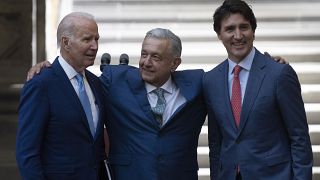 Mexican President Andres Manuel Lopez Obrador embraces President Joe Biden and Canada Prime Minister Justin Trudeau at the North American Leaders' Summit.