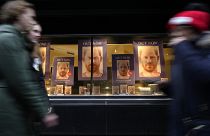 Pedestrians pass a display in the window of a book shop in London on Tuesday. 
